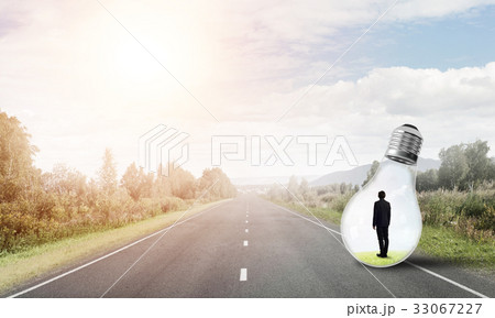 Businessman inside light bulb Businessman inside light bulb 33067227
