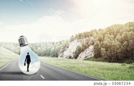 Businesswoman inside light bulb Businesswoman inside light bulb 33067234