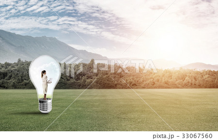 Businesswoman inside light bulb Businesswoman inside light bulb 33067560