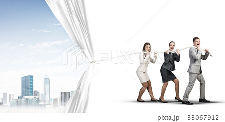 Young businesspeople working in collaboration and pulling white advertisement banner Young businesspeople working in collaboration and pulling white advertisement banner 33067912