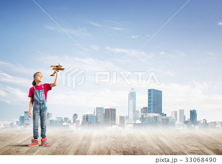 Concept of careless happy childhood with girl dreaming about future Concept of careless happy childhood with girl dreaming about future 33068490