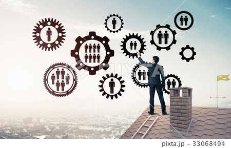 Businessman on house roof presenting teamwork and connection con 33068494