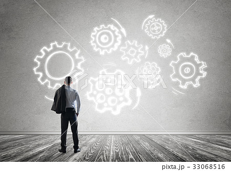 Cogwheel engine drawn on concrete wall as symbol for teamwork and cooperation 33068516