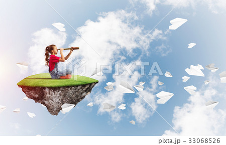 Concept of careless happy childhood with girl looking in spyglass 33068526
