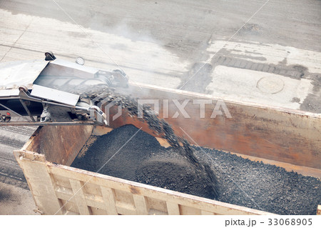 Road works. Asphalt removing machine loading 33068905