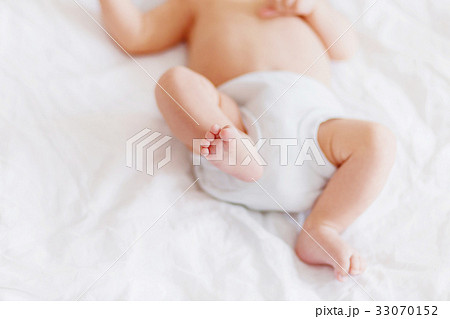 Baby's feet. Little child in bodysuit and diaper. 33070152