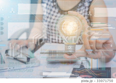 hand holding light bulb with technology graph. 33071750
