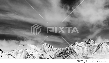 Black and white winter snowy mountains in fog 33072585