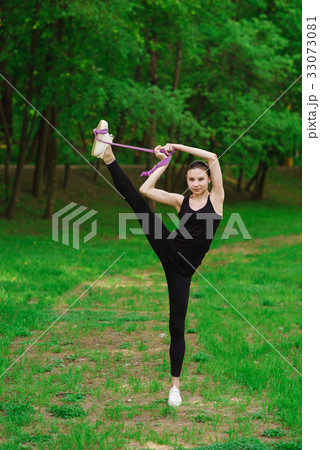 Girl doing stretching outdoors Girl doing stretching outdoors 33073081