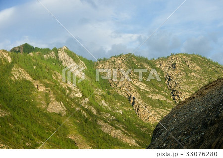 Beautiful sunny valley between mountains with lush 33076280