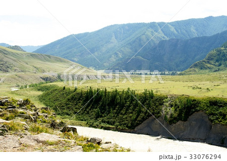 Beautiful sunny valley between mountains with lush Beautiful sunny valley between mountains with lush 33076294