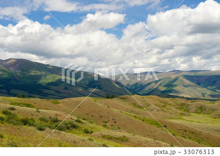 Beautiful sunny valley between mountains with lush Beautiful sunny valley between mountains with lush 33076313