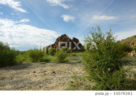 Beautiful sunny valley between mountains with lush Beautiful sunny valley between mountains with lush 33076361