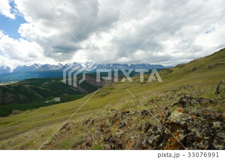 Beautiful sunny valley between mountains with lush 33076991