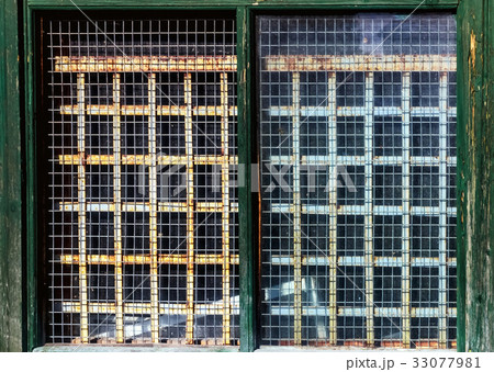 Old small window with bars 33077981