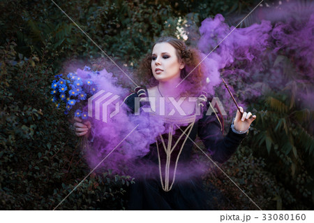 Woman showing tricks with a magic wand. 33080160