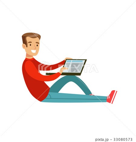 Young smiling man sitting on the floor using his 33080573