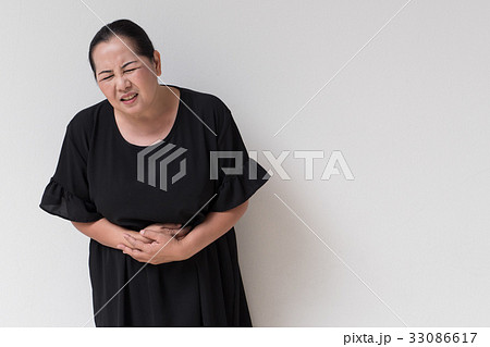 woman suffering from stomach ache, menopause cramp 33086617