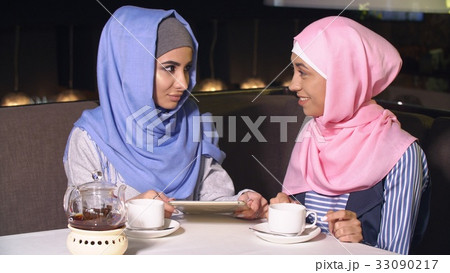 Young girls in hijabs spend time together. 33090217