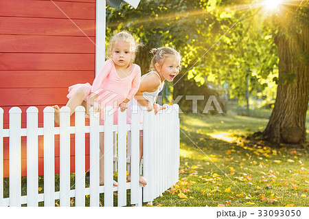 The two little girls at playground against park or The two little girls at playground against park or 33093050