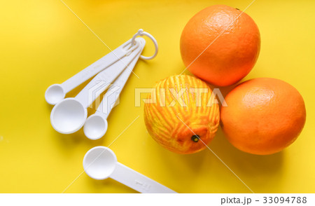 Plastic spoon on yellow background Plastic spoon on yellow background 33094788
