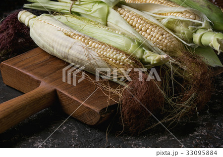 Young raw corn cobs 33095884