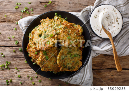 Homemade zucchini fritters with greens Homemade zucchini fritters with greens 33099283