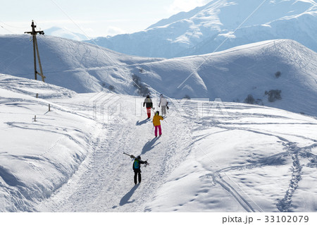 Skiers and snowboarders on snow road at sun winter Skiers and snowboarders on snow road at sun winter 33102079