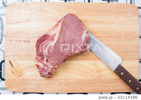 Beef with knife on wooden broad 33114396