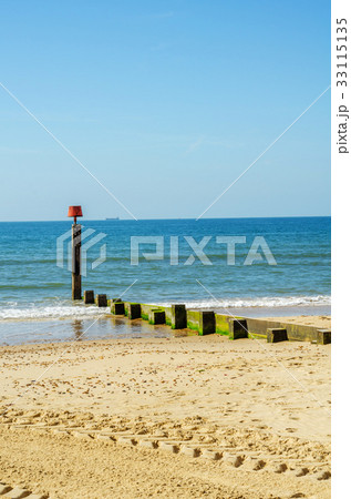 Dock pilings on a sandy beach Dock pilings on a sandy beach 33115135