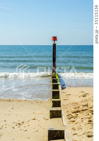 Dock pilings on a sandy beach Dock pilings on a sandy beach 33115136