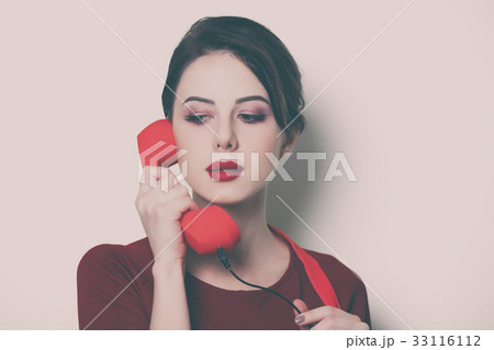 young housewife with red handset 33116112