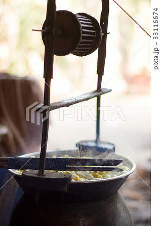 Boiling silkworm cocoon in the pot for process 33116674