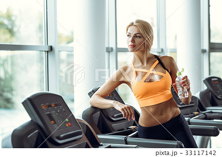 athletic blond woman with bottle of water on 33117142