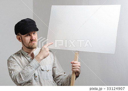 Work young man points finger on a blank banner Work young man points finger on a blank banner 33124907
