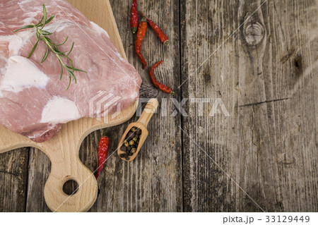Raw pork on a wooden table 33129449