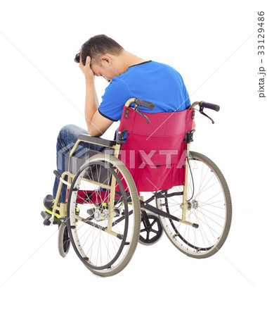 depressed   man sitting on a wheelchair 33129486