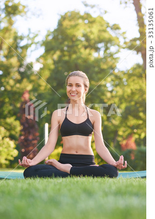 Young woman practicing yoga outdoors at the park 33135061