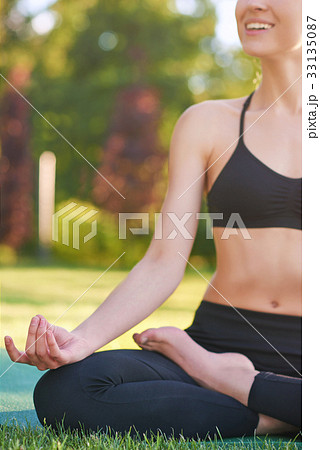 Young woman practicing yoga outdoors at the park 33135087
