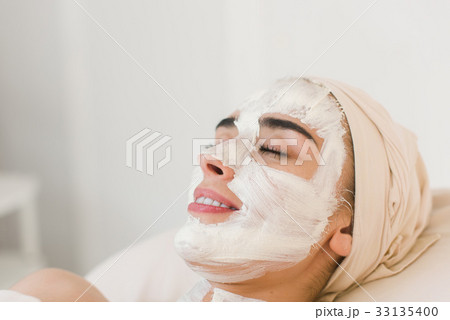 Woman with facial clay mask Woman with facial clay mask 33135400