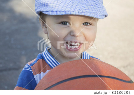 a little boy holds a basketball a little boy holds a basketball 33136202