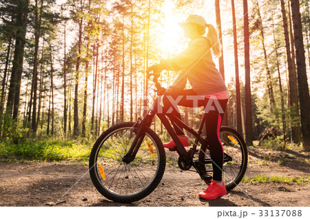 Woman riding a mountain bicycle at the forest 33137088