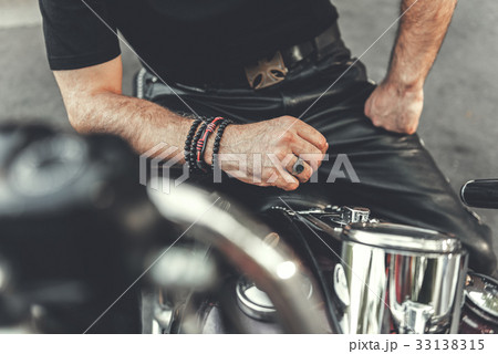 Strong man locating on motorcycle 33138315