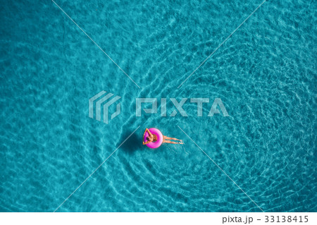 Aerial view of woman swimming on the swim ring 33138415