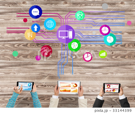 Top view of businesspeople sitting at table and using gadgets Top view of businesspeople sitting at table and using gadgets 33144399