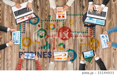 Top view of businesspeople sitting at table and using gadgets Top view of businesspeople sitting at table and using gadgets 33144933