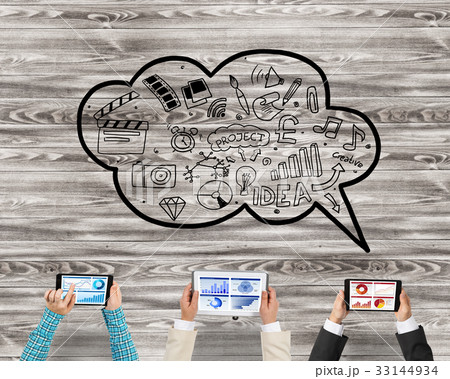 Top view of businesspeople sitting at table and using gadgets 33144934