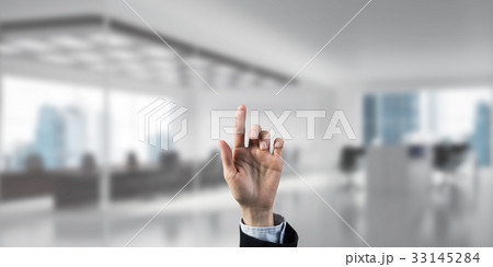 Choosing gesture of businessperson in elegant modern interior in 33145284