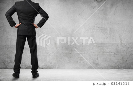 Businessman looking at wall Businessman looking at wall 33145512