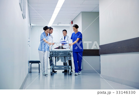 medics and patient on hospital gurney at emergency 33146330